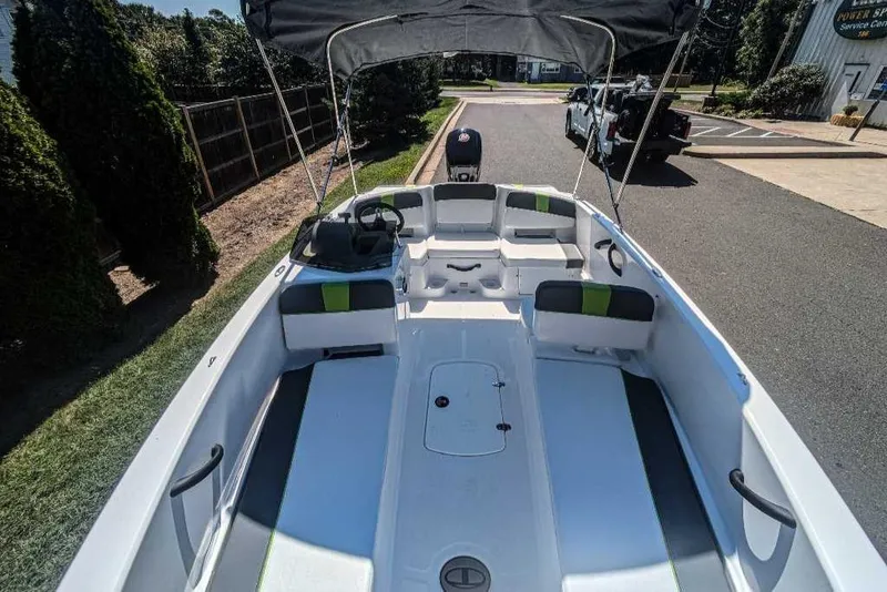 Slide: The Image of 2024 Tahoe T18 boat with spacious seating and canopy on a sunny day. - 3