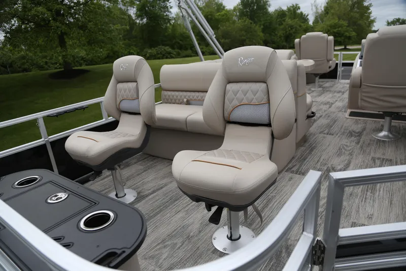 Slide: The Image of 2024 Ranger Reata 220F pontoon boat interior with plush seating and modern design. - 2