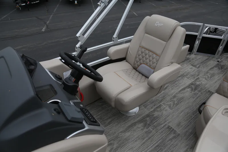 Slide: The Image of 2024 Ranger Reata 220F boat interior with luxurious captain's chair and steering console. - 3