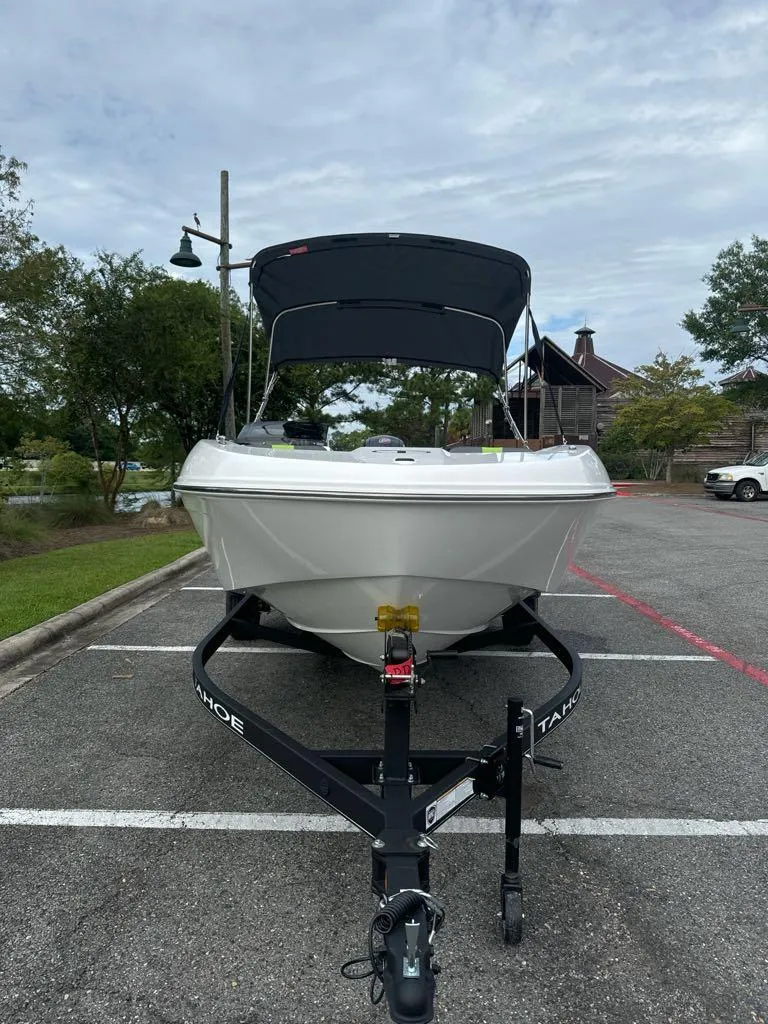 Slide: The Image of 2024 Tahoe T18 boat on trailer in parking lot, overcast sky. - 3