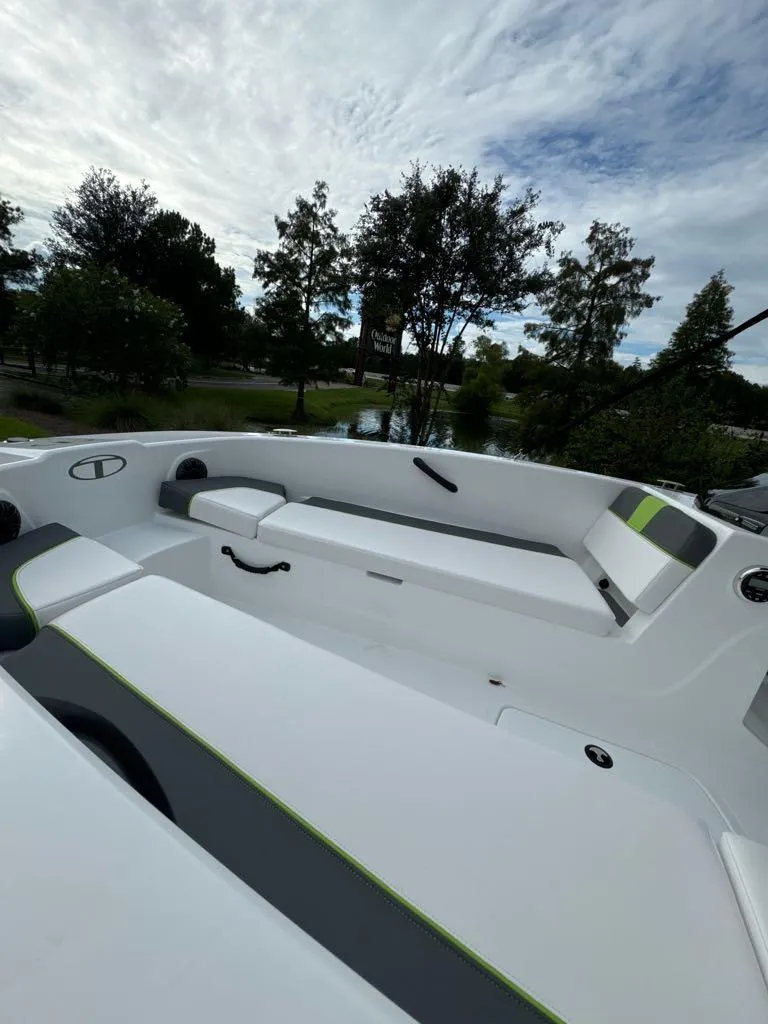 Slide: The Image of 2024 Tahoe T18 boat interior with sleek white seating and green accents. - 4