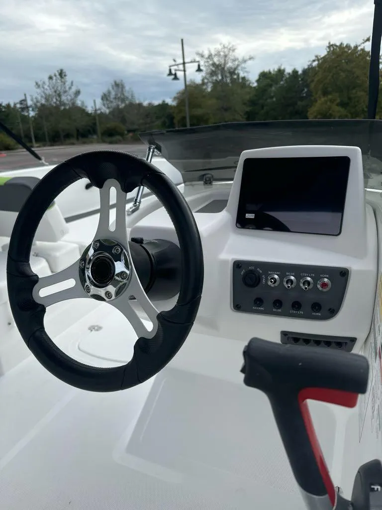 Slide: The Image of 2024 Tahoe T18 boat dashboard with steering wheel and control panel. - 7