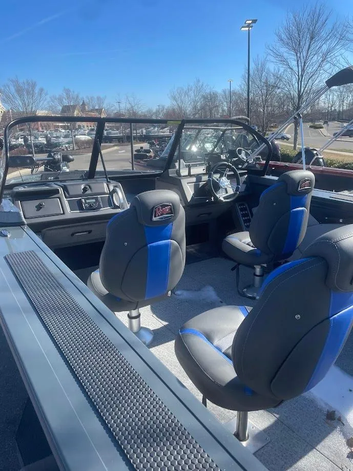 Slide: The Image of 2024 Ranger VX1988 WT boat interior with blue-accented seats and steering console. - 2