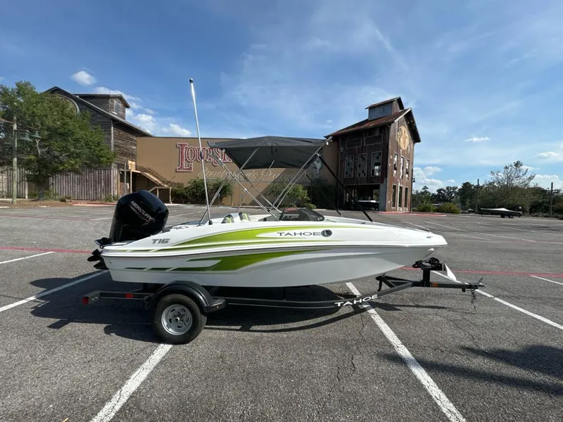 Slide: The Image of 2024 Tahoe T16 boat on trailer in parking lot, sunny day. - 2