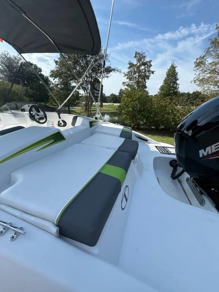 Slide: The Image of 2024 Tahoe T16 boat with seating and Mercury engine, under a clear blue sky. - 6