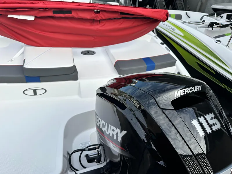 Slide: The Image of 2024 Tahoe T18 boat with Mercury 115 engine, red cover, and sleek design. - 2
