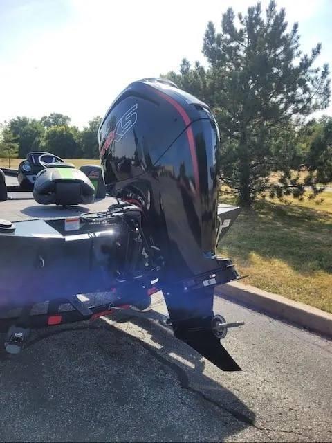 Slide: The Image of 2024 Ranger RT188 boat with powerful outboard motor in a sunny outdoor setting. - 2