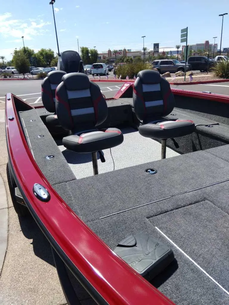 Slide: The Image of 2024 Ranger VS1665T boat with red exterior and comfortable seating. - 3