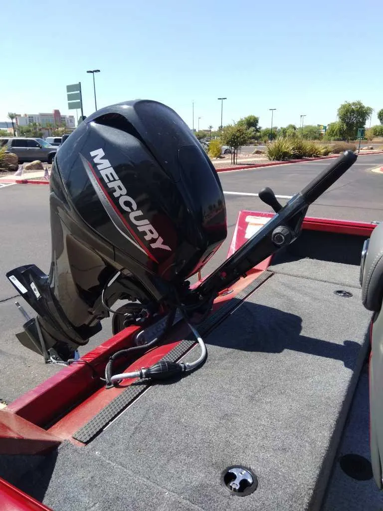 Slide: The Image of 2024 Ranger VS1665T boat with Mercury outboard motor in a parking lot. - 4