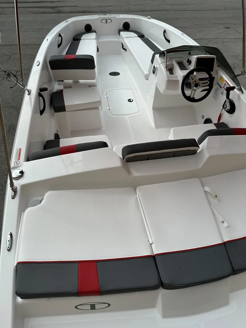 Slide: The Image of 2024 Tahoe T18 boat interior with modern seating and steering console. - 4