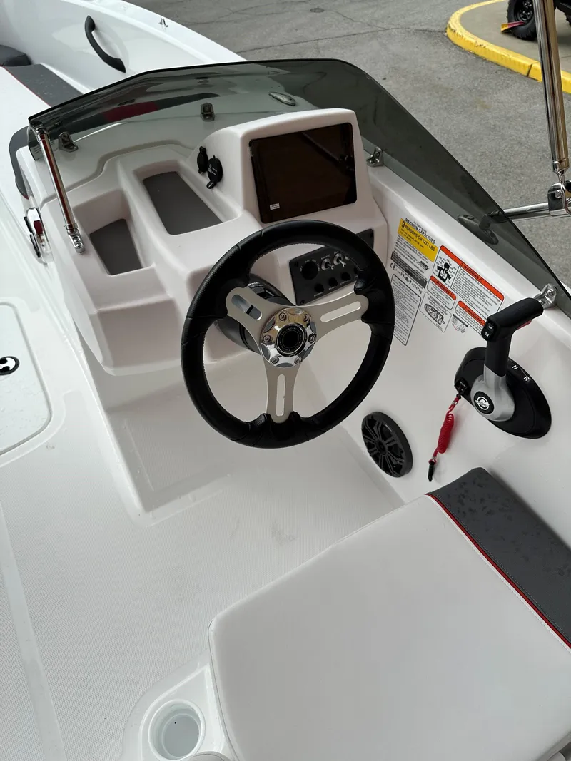Slide: The Image of 2024 Tahoe T18 boat dashboard with steering wheel and control panel. - 6