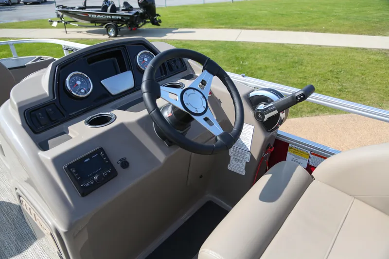 Slide: The Image of 2024 Ranger Reata 200F boat dashboard with steering wheel and control panel. - 3
