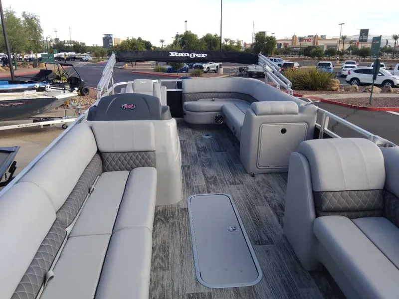 Slide: The Image of 2024 Ranger Reata 223C pontoon boat with spacious seating and modern design. - 1