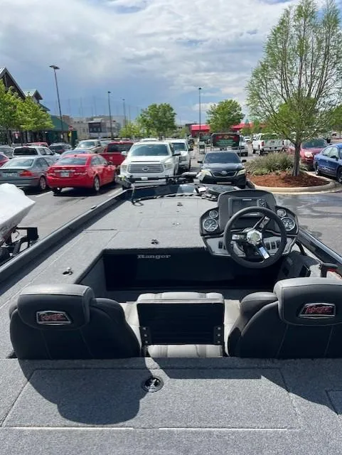 Slide: The Image of 2024 Ranger RT178C boat parked in a lot, showcasing interior and steering console. - 2