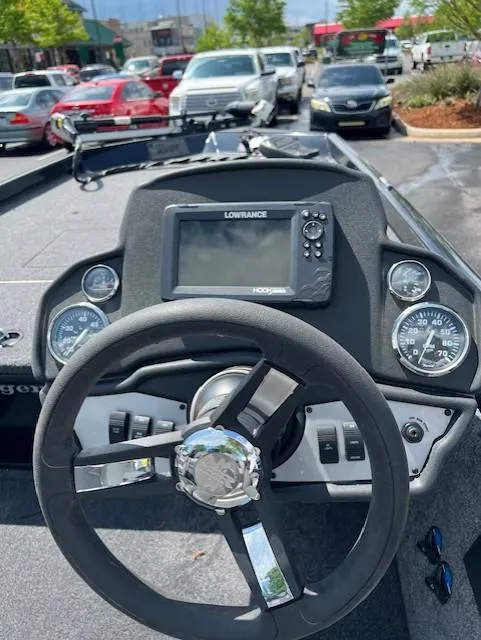 Slide: The Image of 2024 Ranger RT178C boat dashboard with steering wheel and Lowrance fishfinder. - 3