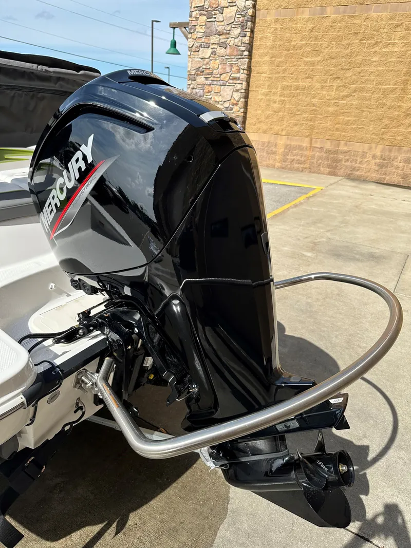 Slide: The Image of 2024 Tahoe T16 boat with Mercury outboard motor in a parking lot. - 2