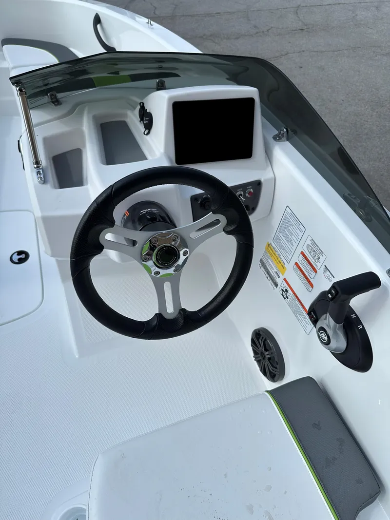 Slide: The Image of 2024 Tahoe T16 boat dashboard with steering wheel and control panel. - 5