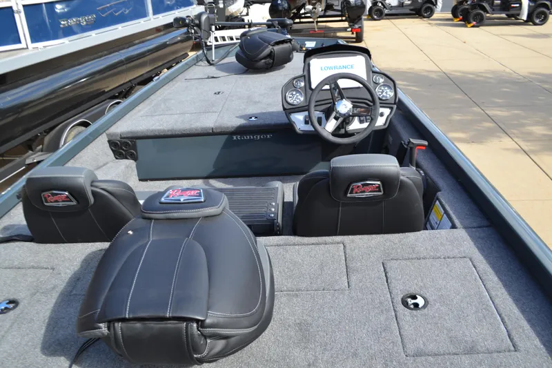 Slide: The Image of 2024 Ranger RT188 boat interior with steering console and seating. - 2