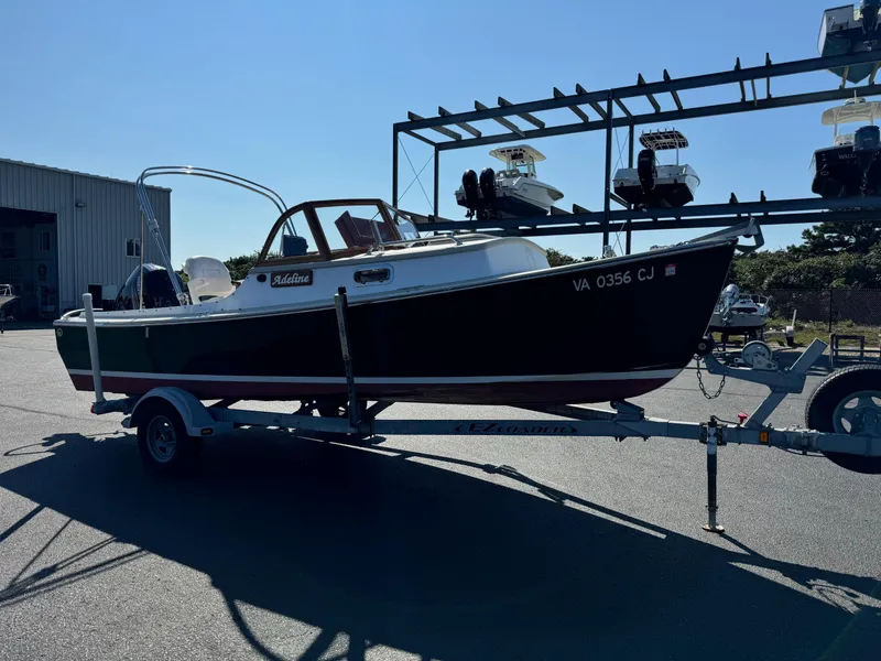 Slide: The Image of 2015 Devlin Pelicano 20 boat on trailer in sunny marina. - 11