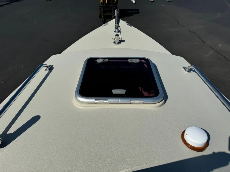 Slide: The Image of Devlin Pelicano 20 boat deck, 2015 model, featuring a hatch and railings. - 13