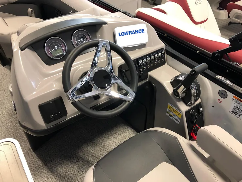 Slide: The Image of Barletta ARIA 20UC 2025 boat dashboard with steering wheel and controls. - 9