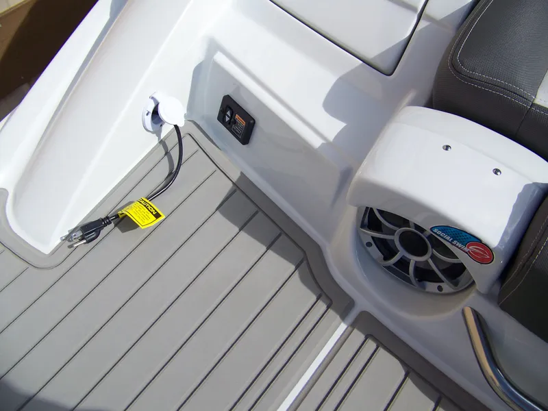 Slide: The Image of 2023 Crownline Eclipse E255 boat interior with speaker and power outlet. - 16