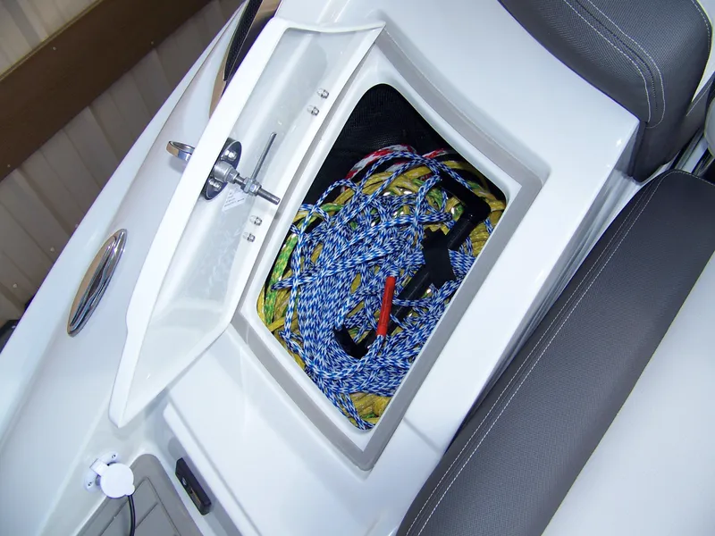 Slide: The Image of 2023 Crownline Eclipse E255 boat storage compartment with ropes and accessories. - 17