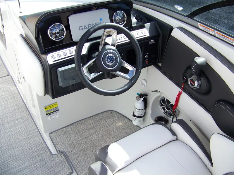 Slide: The Image of 2023 Crownline Eclipse E255 boat cockpit with Garmin display and modern steering wheel. - 6