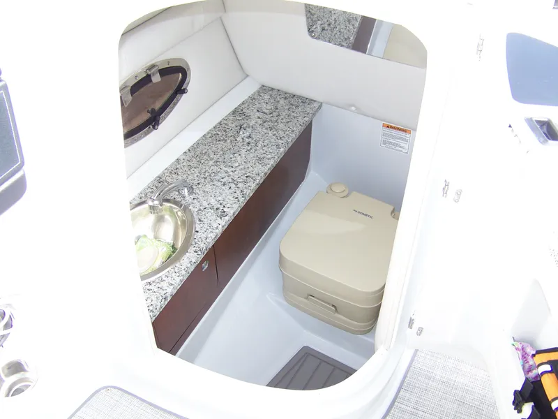 Slide: The Image of 2023 Crownline Eclipse E255 boat interior with sink and portable toilet. - 7
