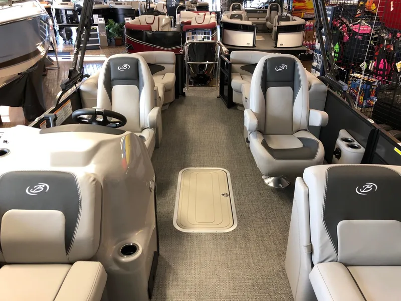 Slide: The Image of 2025 Barletta ARIA 22QC pontoon boat interior with gray seating and steering console. - 6