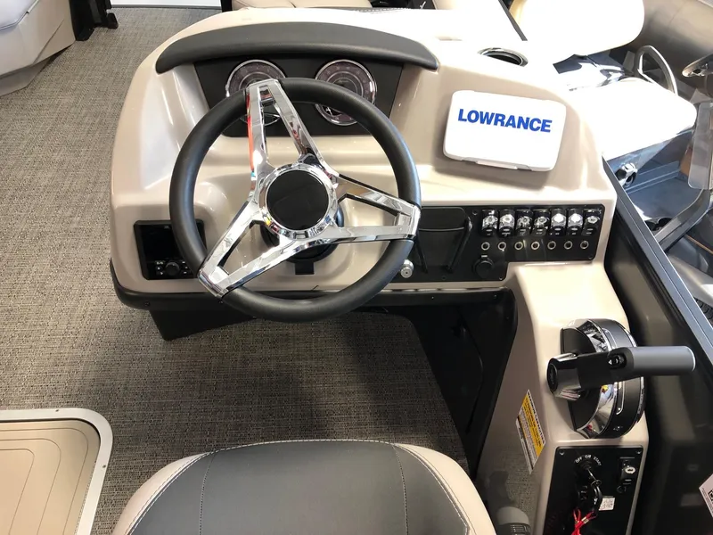 Slide: The Image of 2025 Barletta ARIA 22QC boat dashboard with steering wheel and Lowrance navigation system. - 8