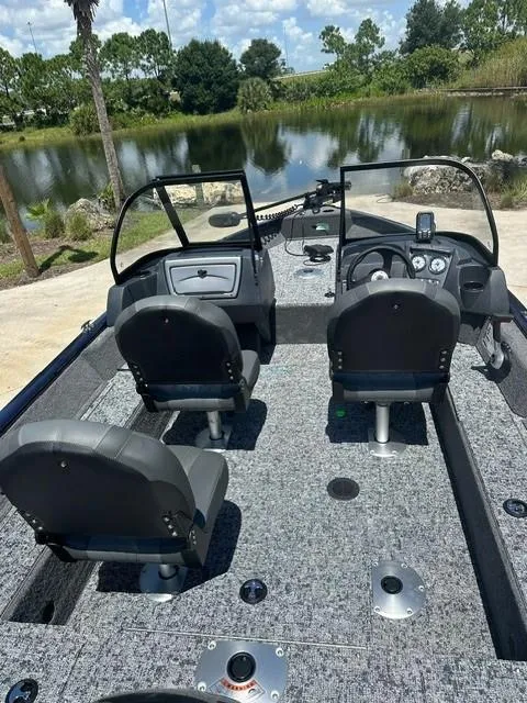 Slide: The Image of 2025 Bass Tracker PGV16WT boat interior with dual seats and steering console. - 6