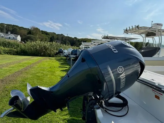 Slide: The Image of 2021 Parker 2320 Sport Cabin with Yamaha 250 outboard motor on grassy field. - 3