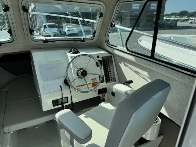 Slide: The Image of 2021 Parker 2320 Sport Cabin interior with steering wheel and control panel. - 7
