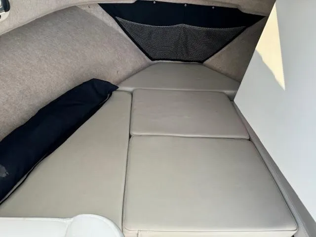 Slide: The Image of 2021 Parker 2320 Sport Cabin interior with cushioned sleeping area. - 8