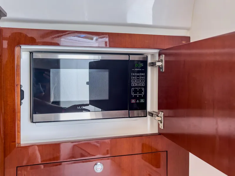 Slide: The Image of Built-in microwave in 2017 Intrepid 430 Sport Yacht's wooden cabinet. - 15
