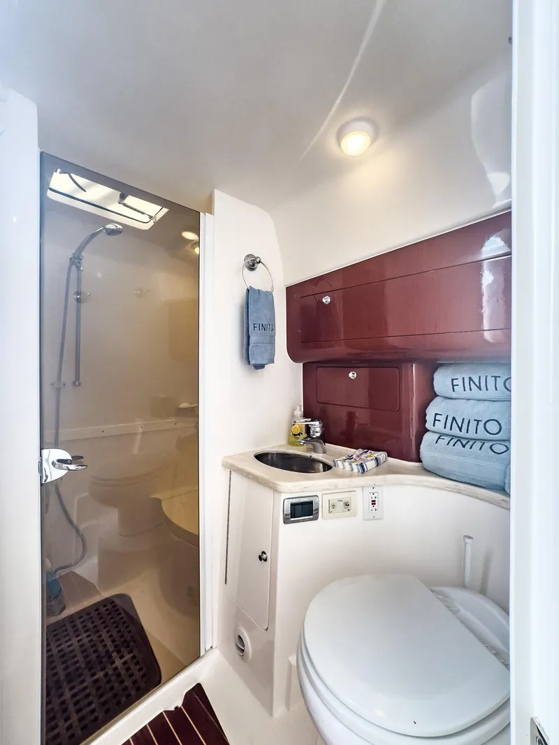 Slide: The Image of 2017 Intrepid 430 Sport Yacht bathroom with shower, sink, and storage cabinets. - 18