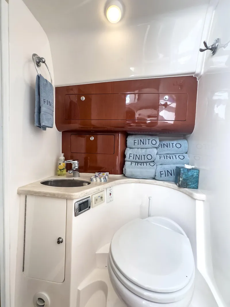 Slide: The Image of Bathroom of 2017 Intrepid 430 Sport Yacht with sink, toilet, and storage cabinets. - 19