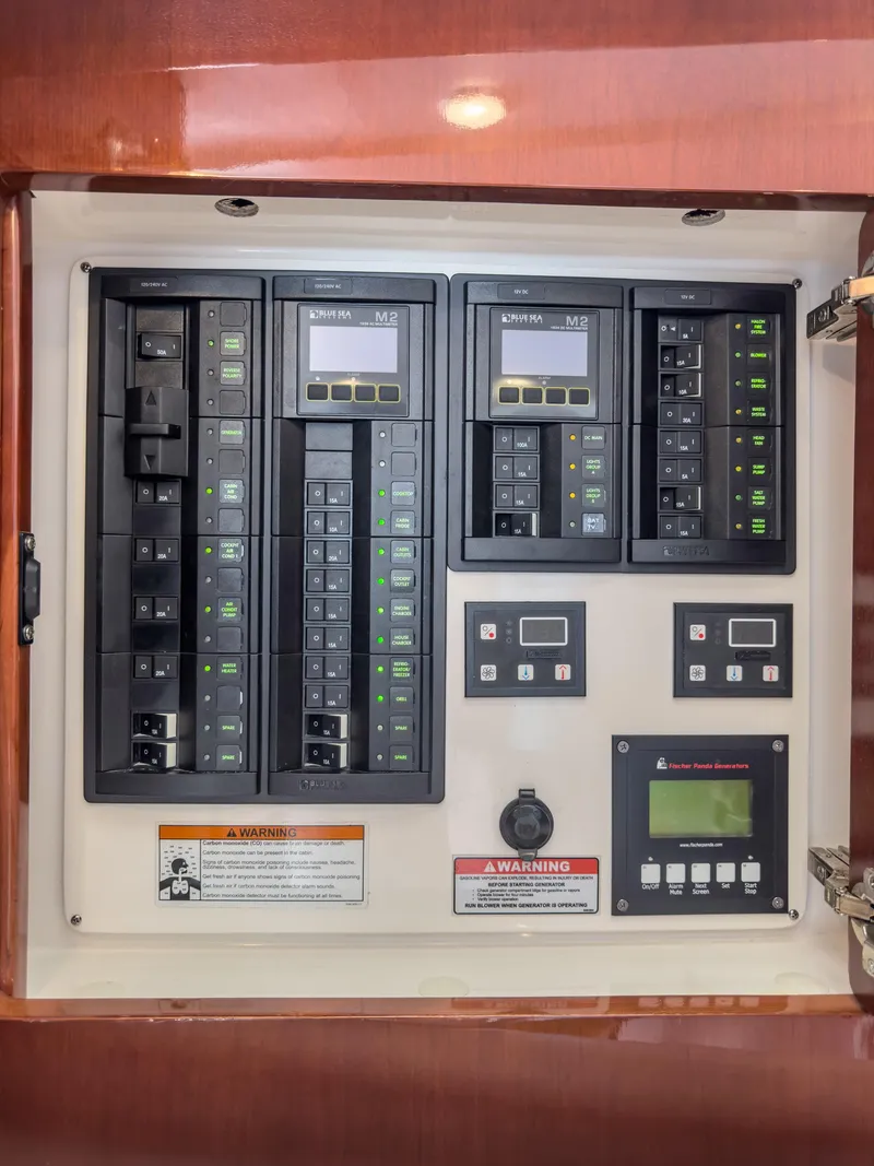 Slide: The Image of Electrical panel of a 2017 Intrepid 430 Sport Yacht with various switches and controls. - 20