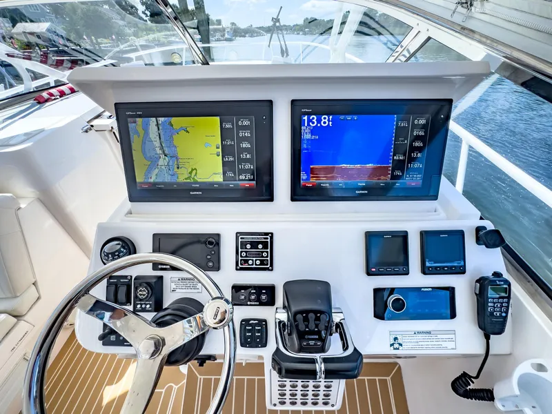 Slide: The Image of Helm of 2017 Intrepid 430 Sport Yacht with navigation screens and controls. - 27