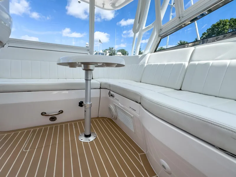 Slide: The Image of 2017 Intrepid 430 Sport Yacht interior with white seating and table. - 32
