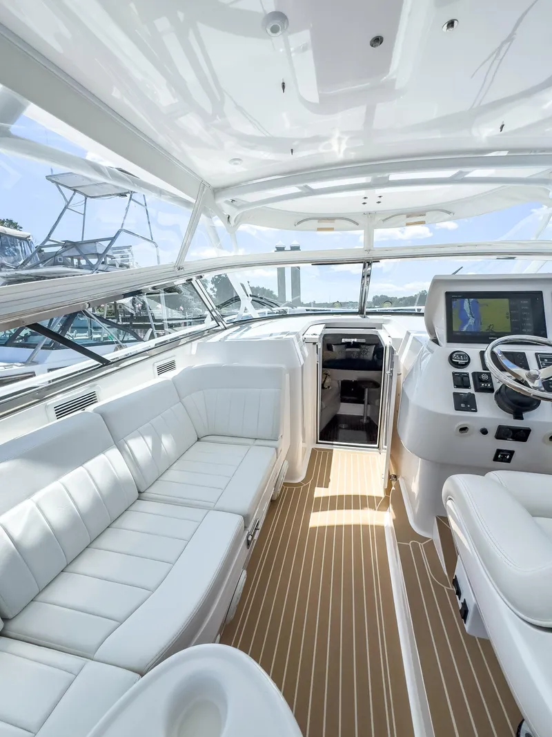 Slide: The Image of Luxurious 2017 Intrepid 430 Sport Yacht interior with plush seating and modern helm. - 33
