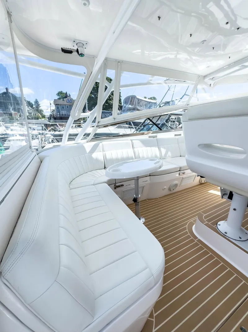 Slide: The Image of 2017 Intrepid 430 Sport Yacht interior with white seating and teak flooring. - 34