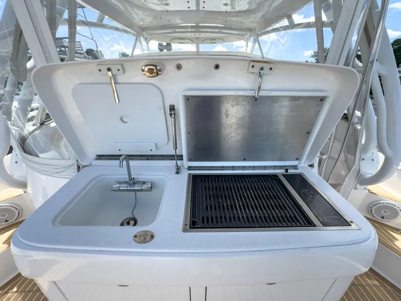Slide: The Image of Outdoor kitchen on 2017 Intrepid 430 Sport Yacht with sink and grill. - 43
