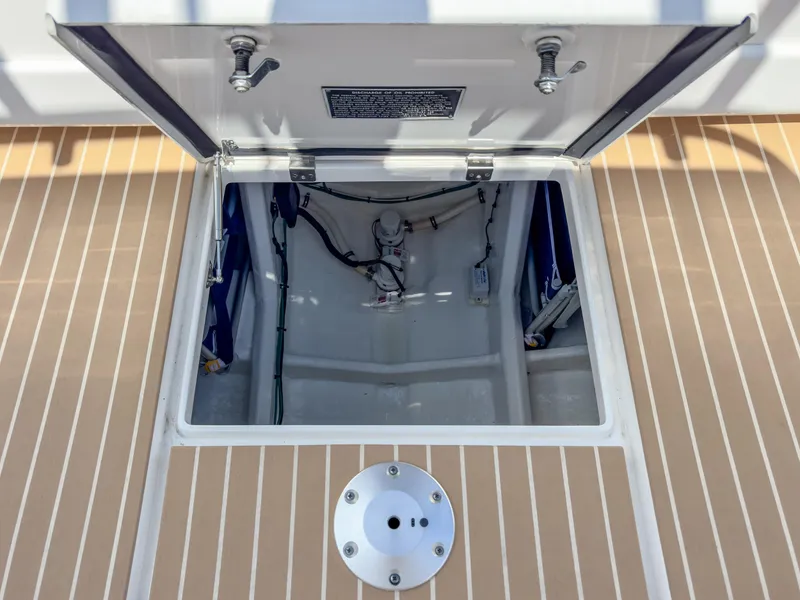 Slide: The Image of Open hatch on 2017 Intrepid 430 Sport Yacht deck, revealing interior components. - 44