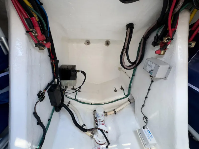 Slide: The Image of Engine compartment of a 2017 Intrepid 430 Sport Yacht with visible wiring and components. - 48
