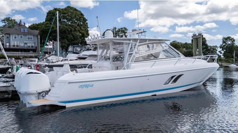 Slide: The Image of 2017 Intrepid 430 Sport Yacht docked at a marina under a partly cloudy sky. - 6
