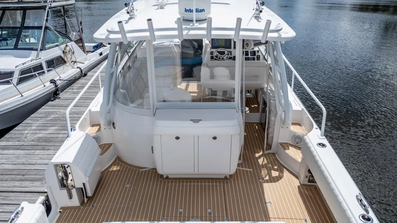 Slide: The Image of 2017 Intrepid 430 Sport Yacht docked, showcasing spacious deck and sleek design. - 8