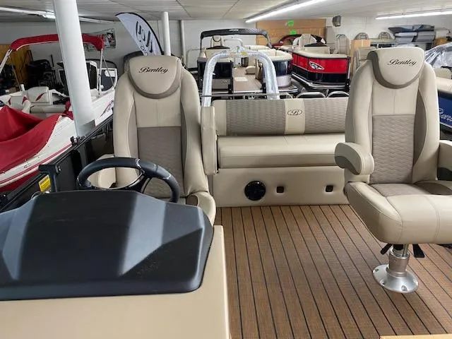 Slide: The Image of 2024 Bentley Pontoons 223 Elite Swing Back interior with luxurious seating and helm. - 11
