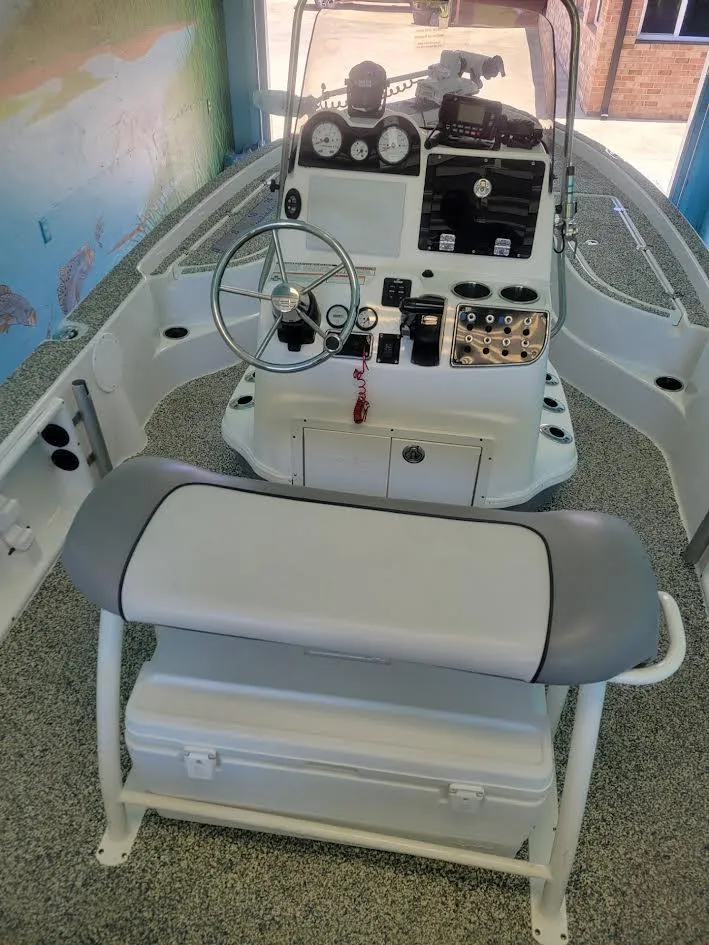 Slide: The Image of 2021 NauticStar 215 XTS boat interior with steering console and seating. - 5